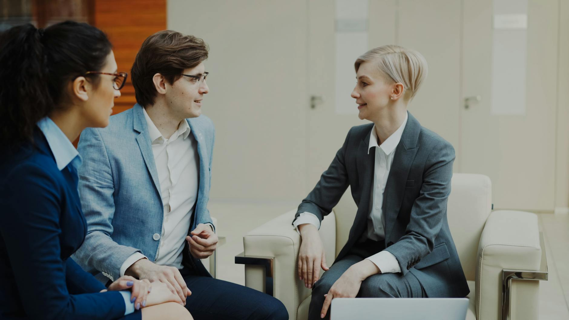 business meeting with three professionals indoors