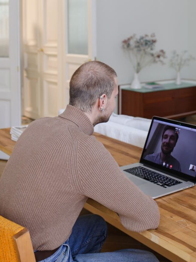 back view of a man video calling his friend